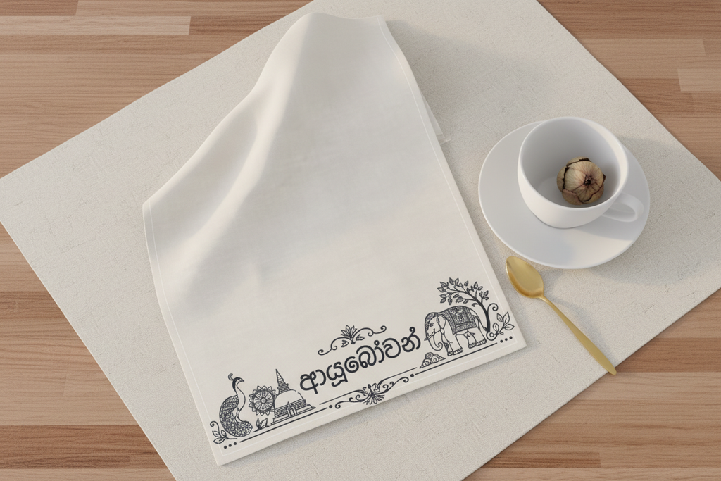 Ayubowan tea towel flat lay with white tea cup and dried lotus bud — Ceylon Culture Vibes