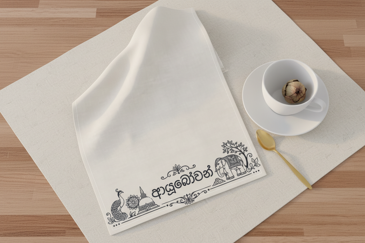 Ayubowan tea towel flat lay with white tea cup and dried lotus bud — Ceylon Culture Vibes