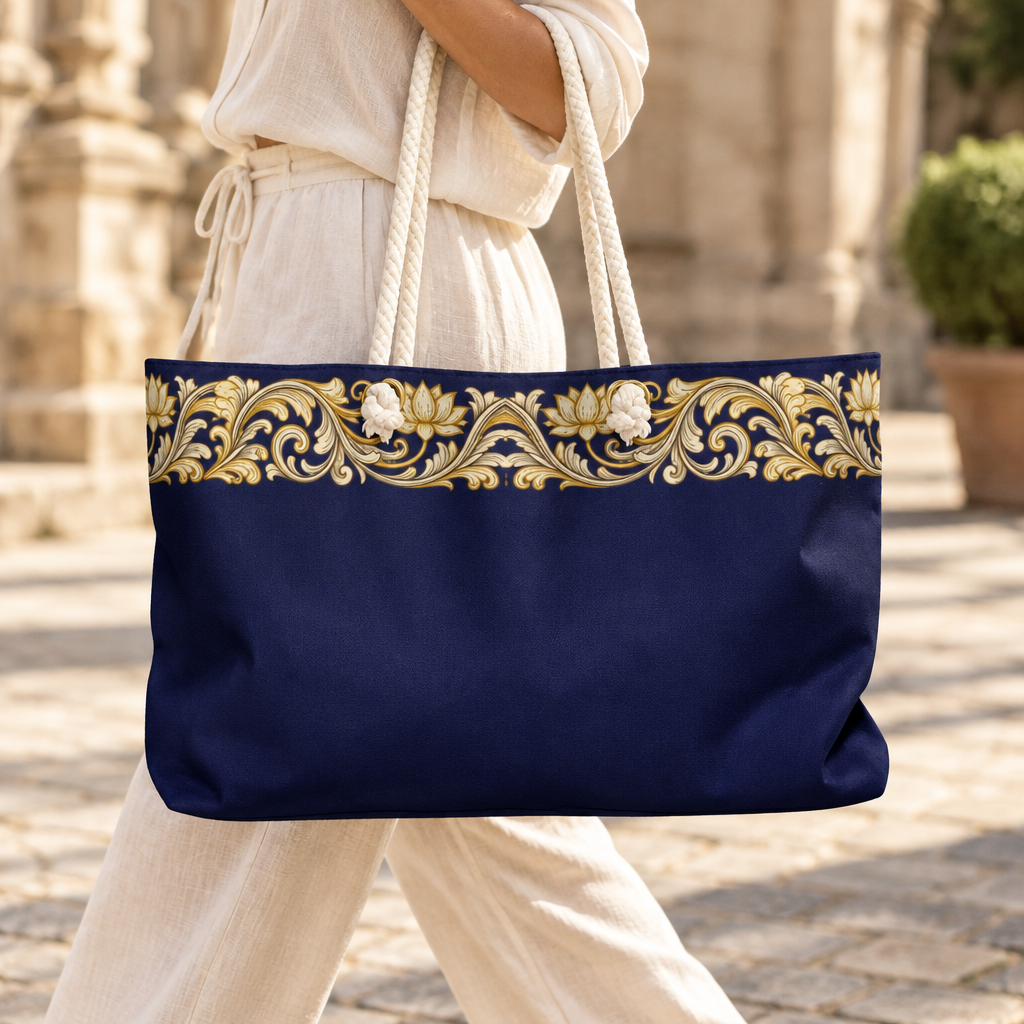 Navy and gold baroque weekender bag carried by its cream rope handles in a sunlit courtyard — Ceylon Culture Vibes