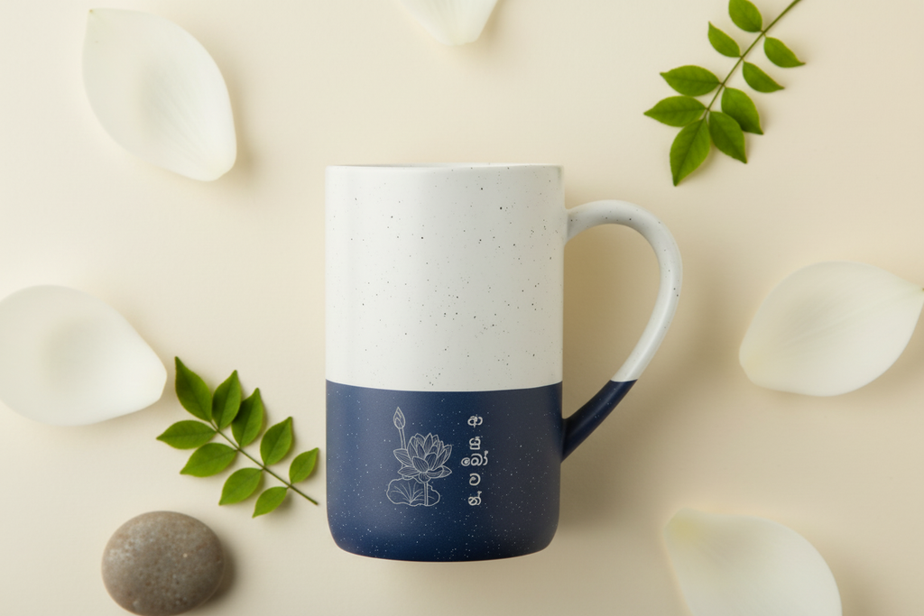 Ayubowan lotus mug lifestyle close-up with green leaf and lotus petal — Ceylon Culture Vibes