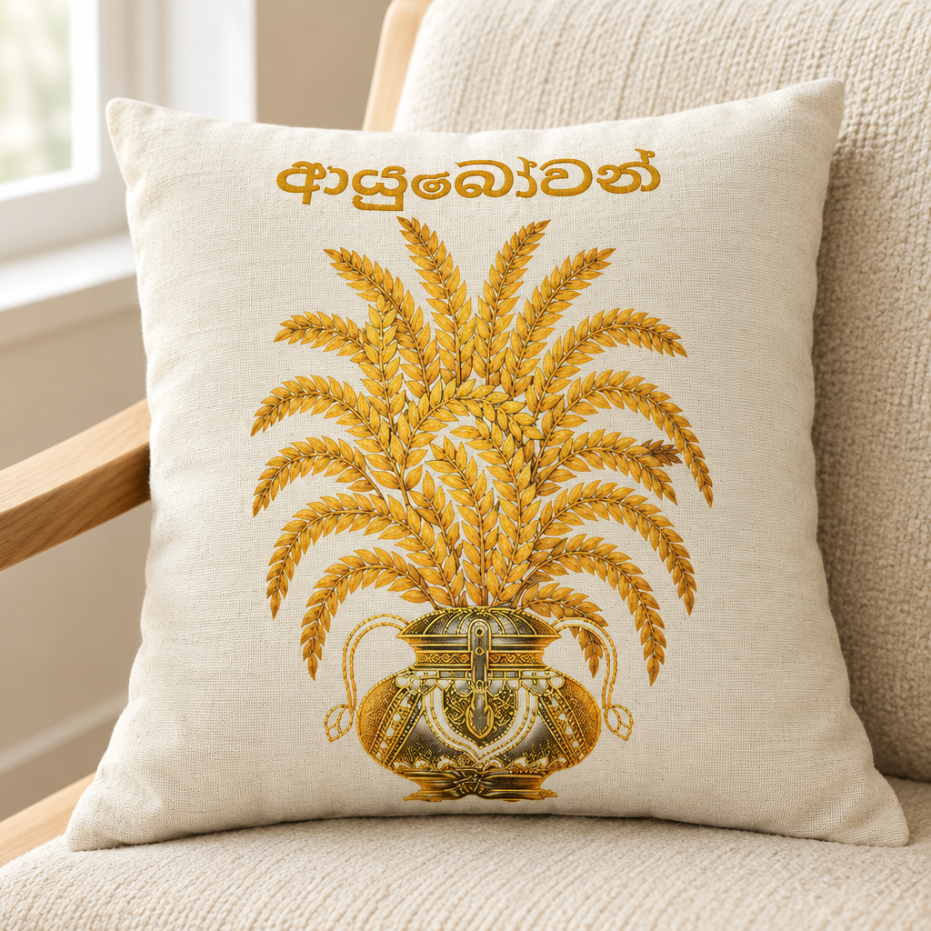Ivory square pillow with gold paddy stalks, vessel and Sinhala lettering on a cream chair — Ceylon Culture Vibes