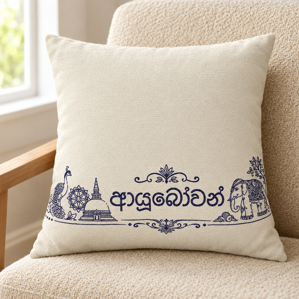 Ivory square cushion with Sinhala script and Sri Lankan line drawings on a cream chair — Ceylon Culture Vibes